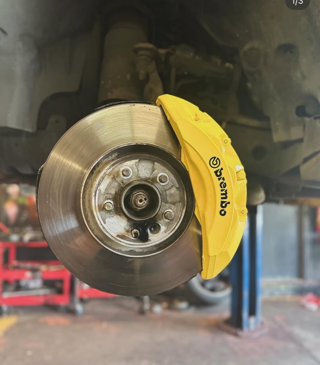 Yellow painted Brembo brake caliper