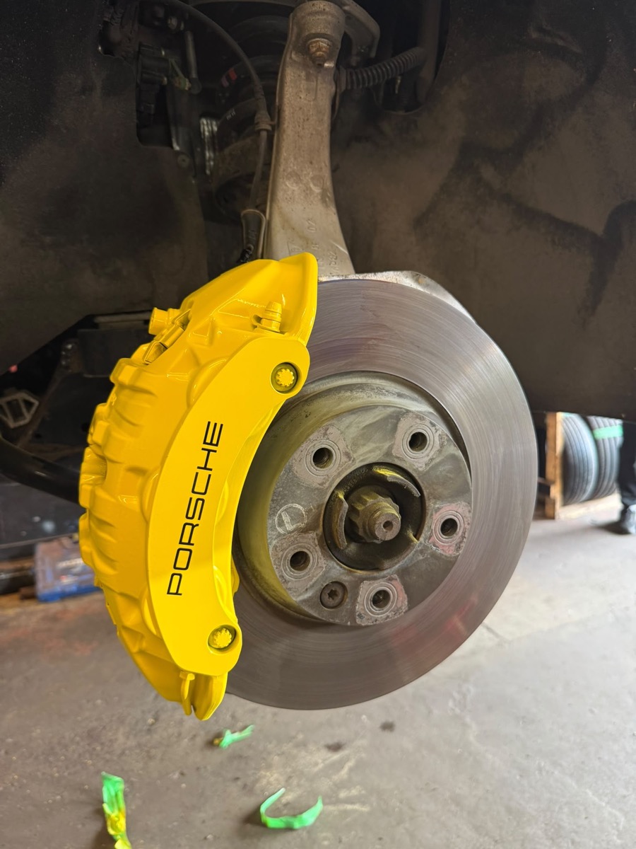 Yellow painted Porsche brake caliper
